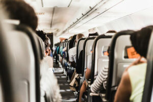 Passengers seated in airplane cabin during flight - natural travel wellness tips for Indian travelers