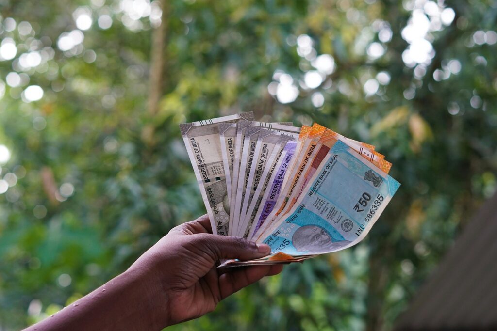 Indian rupee currency notes held in hand showing ₹50 and other denominations — cash hygiene and fungal contamination risks in India