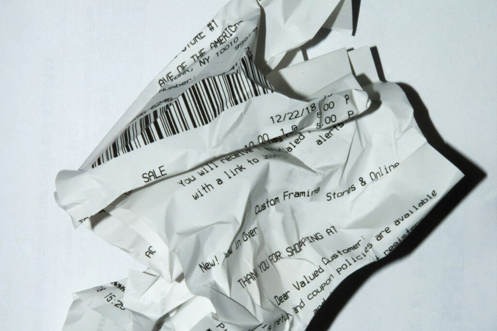 Crumpled thermal paper receipt — hidden source of BPA and BPS endocrine disruptors that absorb through skin on contact